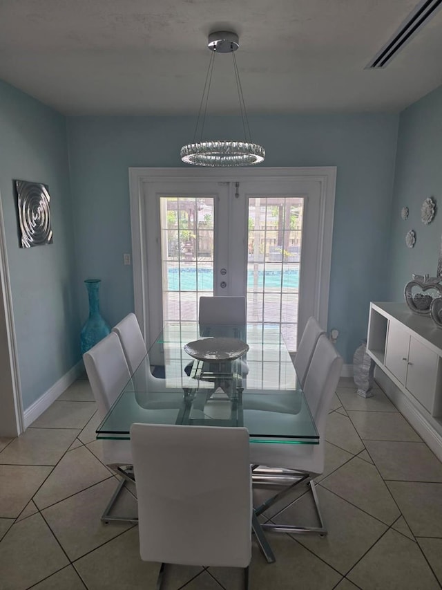 10611 SW 164th St, Miami, FL 33157 - dining area with light tile patterned floors, french doors, and baseboards