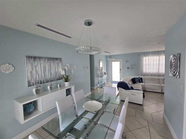10611 SW 164th St, Miami, FL 33157 - dining space featuring a chandelier, baseboards, and light tile patterned floors