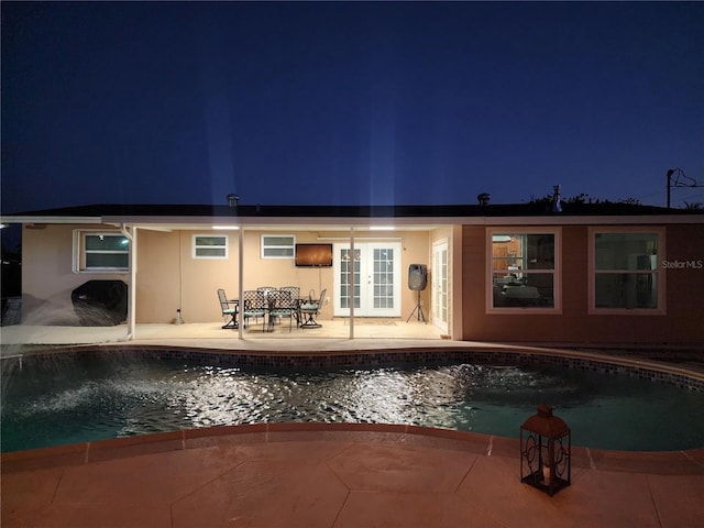 10611 SW 164th St, Miami, FL 33157 - back of property featuring french doors, an outdoor pool, a patio, and stucco siding
