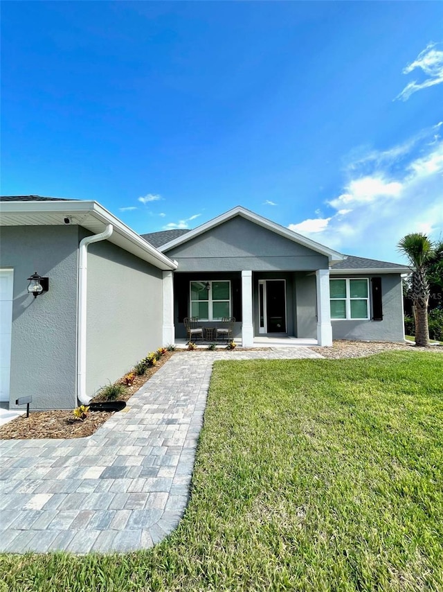 view of front of home featuring covered porch and a front yard