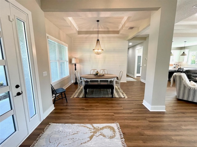 dining space featuring dark hardwood / wood-style flooring and a raised ceiling