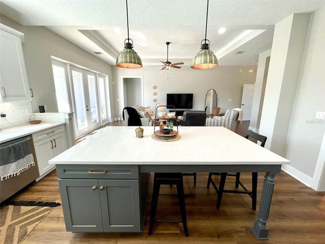 kitchen featuring french doors, tasteful backsplash, ceiling fan, decorative light fixtures, and dishwasher