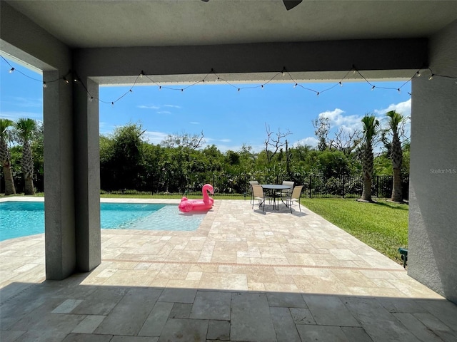 view of swimming pool featuring a yard and a patio area