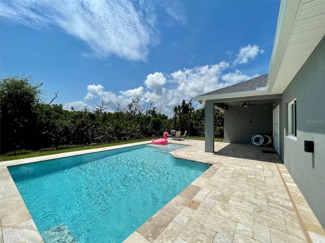 view of pool with ceiling fan and a patio area