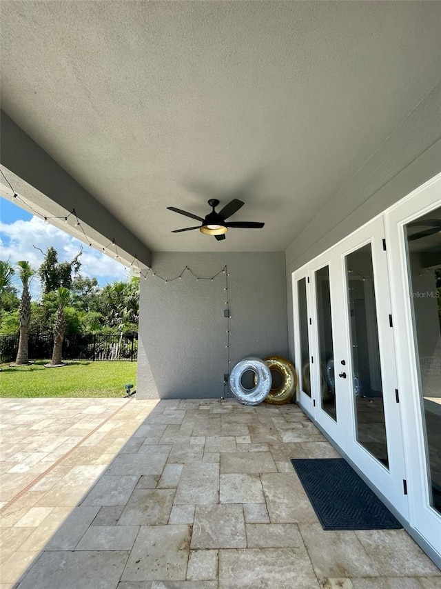 view of patio featuring french doors and ceiling fan