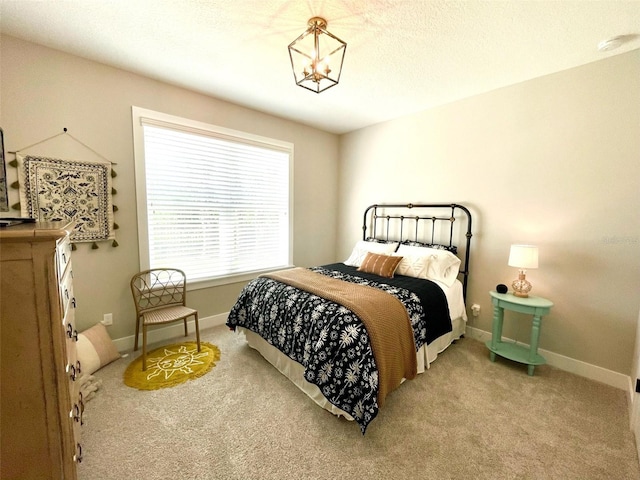 bedroom featuring carpet floors and an inviting chandelier