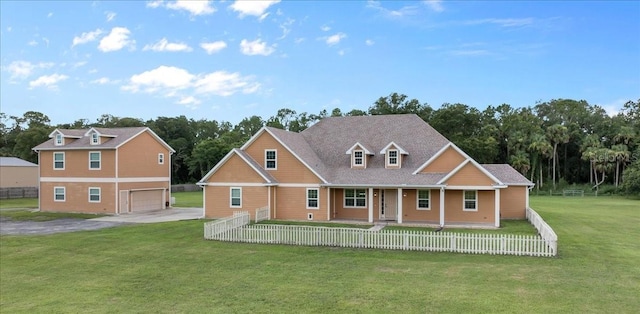 view of front of home with a front yard, a garage, and covered porch