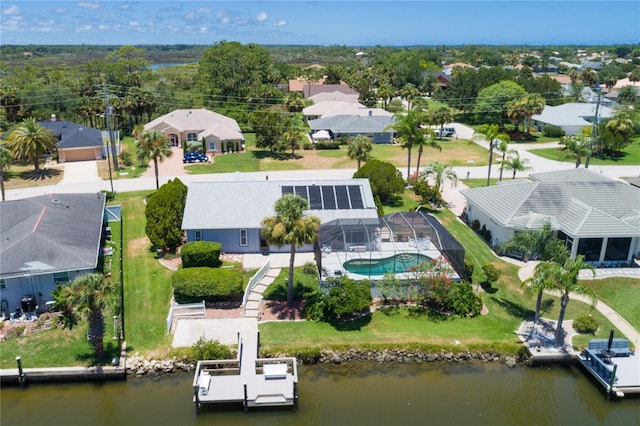 birds eye view of property with a residential view and a water view