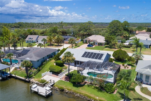 birds eye view of property with a residential view and a water view