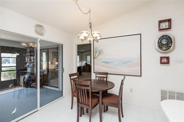 dining room with baseboards, lofted ceiling, and an inviting chandelier