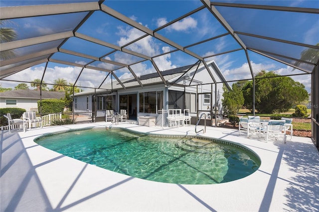 view of swimming pool with a lanai and a patio area