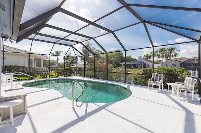 view of swimming pool with a patio area and glass enclosure