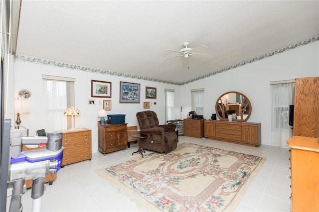 tiled office featuring a textured ceiling and ceiling fan