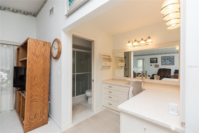 bathroom featuring walk in shower, tile patterned flooring, vanity, and toilet