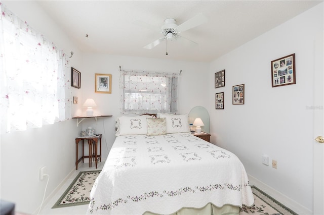 bedroom featuring baseboards and ceiling fan