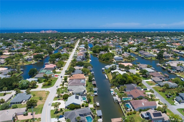 drone / aerial view featuring a residential view and a water view