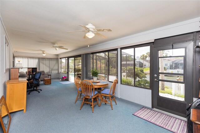 sunroom / solarium featuring ceiling fan