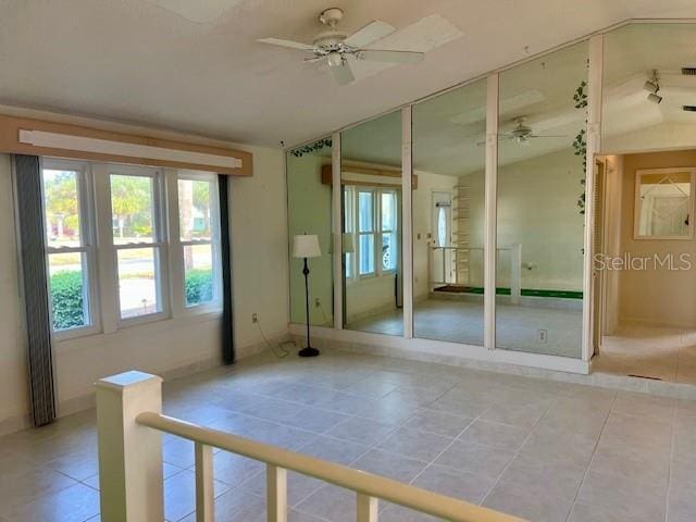 entryway with ceiling fan and lofted ceiling