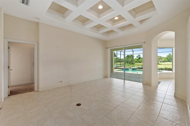 spare room featuring a high ceiling, coffered ceiling, and beamed ceiling