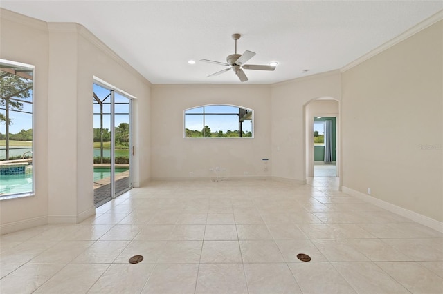 tiled spare room with crown molding, a water view, and ceiling fan