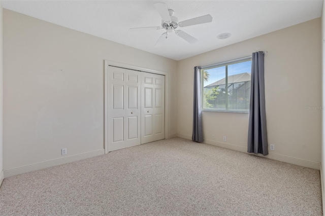 unfurnished bedroom with ceiling fan, light colored carpet, and a closet