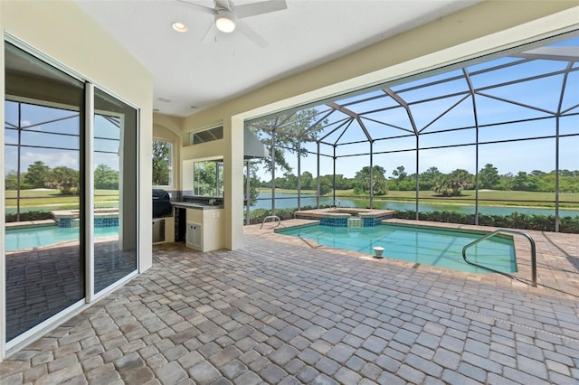 view of pool featuring an in ground hot tub, a water view, a lanai, and a patio area