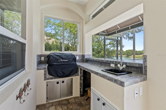 view of patio / terrace with area for grilling, an outdoor kitchen, and sink