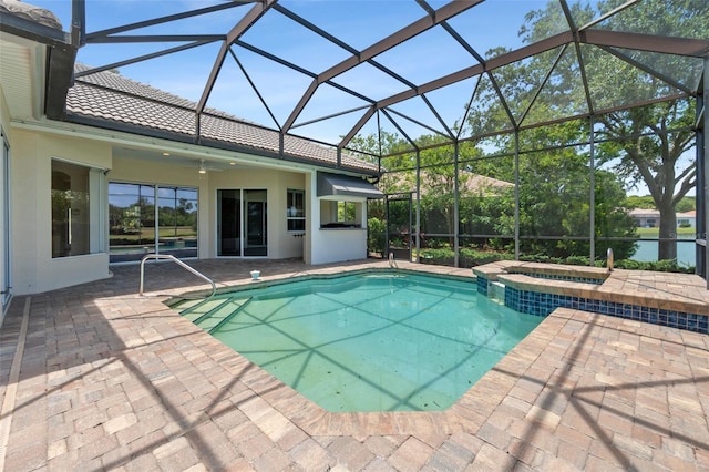 view of swimming pool with an in ground hot tub, a lanai, and a patio