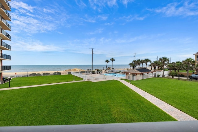 view of yard featuring a water view and a community pool