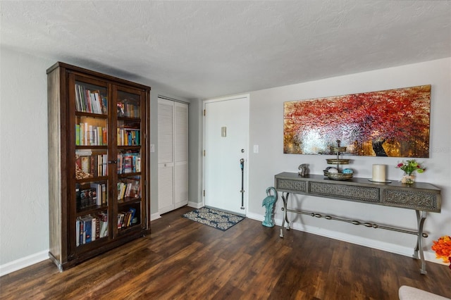 entrance foyer featuring dark hardwood / wood-style flooring and a textured ceiling