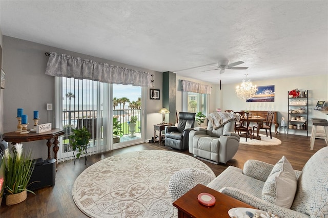 living room featuring a textured ceiling, ceiling fan, and dark hardwood / wood-style floors