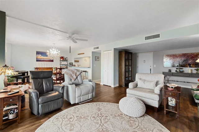 living room featuring ceiling fan with notable chandelier and dark hardwood / wood-style floors