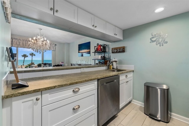 kitchen with an inviting chandelier, white cabinetry, stainless steel dishwasher, and sink