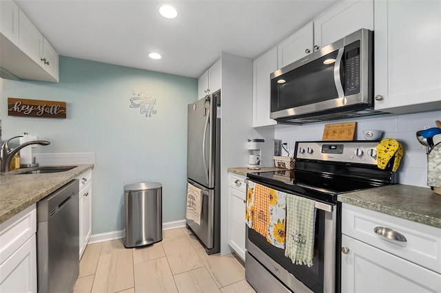 kitchen featuring white cabinets, backsplash, stainless steel appliances, and sink