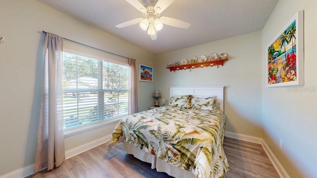 bedroom featuring ceiling fan and hardwood / wood-style flooring