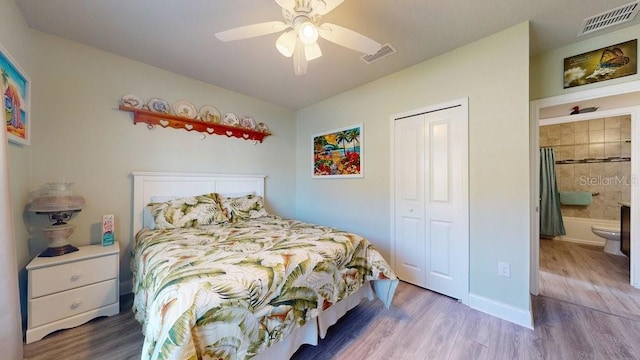 bedroom with wood-type flooring, a closet, ceiling fan, and ensuite bathroom