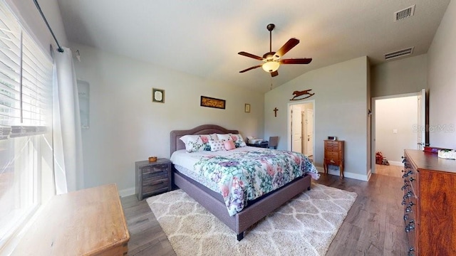 bedroom featuring dark hardwood / wood-style floors, vaulted ceiling, and ceiling fan