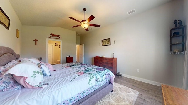 bedroom featuring hardwood / wood-style floors, ceiling fan, and lofted ceiling