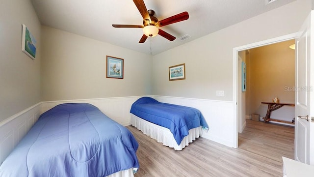 bedroom with ceiling fan and light hardwood / wood-style floors