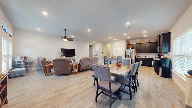 dining space featuring ceiling fan, a healthy amount of sunlight, and light wood-type flooring