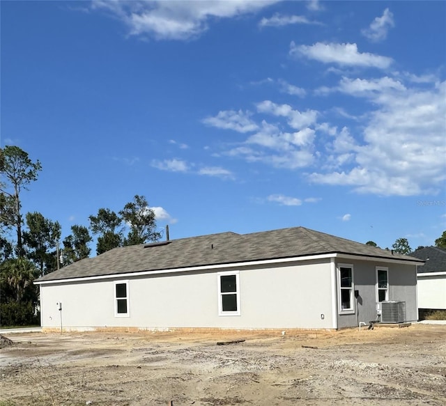 back of property featuring central AC unit