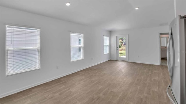 spare room with light hardwood / wood-style flooring