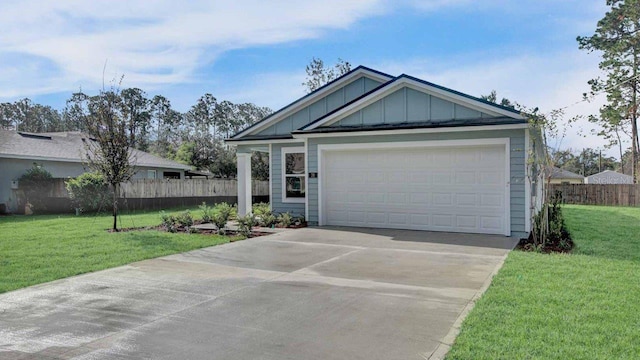 view of front of house featuring a front lawn and a garage