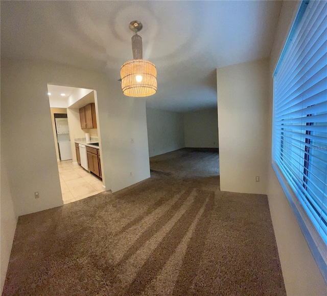 unfurnished dining area with light carpet and light tile patterned flooring