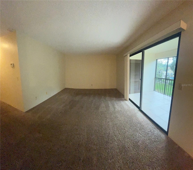 carpeted empty room with a textured ceiling