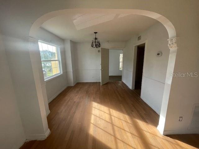 empty room with hardwood / wood-style flooring