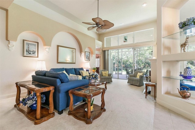 living room with ceiling fan, light tile patterned floors, and built in shelves