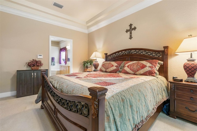 bedroom featuring light colored carpet, crown molding, and connected bathroom