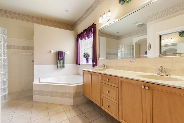 bathroom featuring shower with separate bathtub, tile walls, vanity, and tile patterned flooring