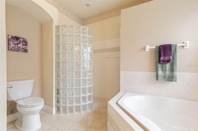 bathroom featuring toilet, tile patterned flooring, and shower with separate bathtub